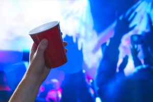 Young Man Holding a Red Cup